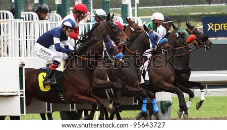 ARCADIA, CA - FEB 19: Jockeys and horses break from the gate for the 1st race at Santa Anita Park in Arcadia, CA, on Feb 19, 2012. Eventual winner is No. 2 Good Gal Friday with Chantal Sutherland up.