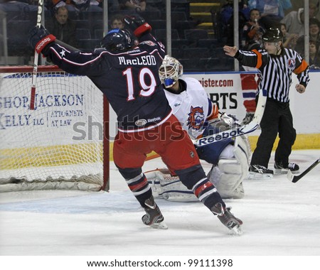 BRIDGEPORT, CT - MAR 30: The referee signals a goal & Springfield Falcon Wade MacLeod celebrates, but the Falcons are defeated by the Bridgeport Sound Tigers 6-2 on March 30, 2012 in Bridgeport, CT.