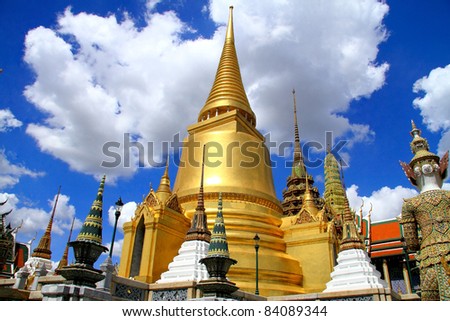 Gold pagoda, white cloud and blue sky at Wat Phra Kaew Grand Palace in Bangkok, Thailand