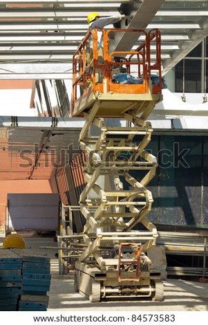 Construction worker Painting Beam using Hydraulic Scissor Lift
