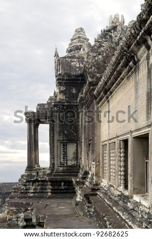 Architecture of the upper tower area of Angkor Wat against the early morning clouds and sky.