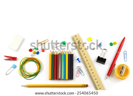 School supplies: colored pencils, wooden yardstick, erasers, binders, stationery gum, paper clips, pencil sharpener, a small clothespin, colored pins, pencil and pen isolated on white background