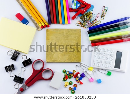 Education concept. Top view of blank board with school and office supplies on white background