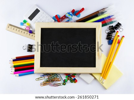 Education concept. Top view of blank blackboard with school and office supplies on white background