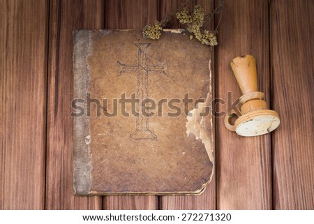 Religious concept. Top view of blank shabby old psalm book with candlestick and dried wild flowers on wooden table
