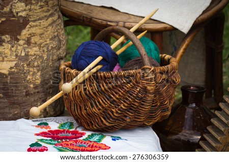 Wooden basket with colored yarn balls in the villiage style