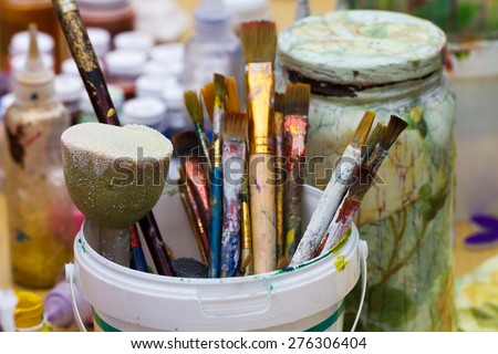 Old size paint brushes in a pot for painting