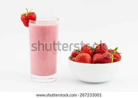 Strawberry smoothie with fresh strawberry in the plate isolated on white background