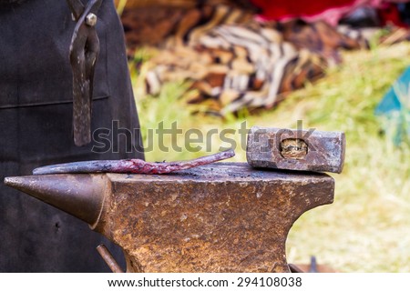 Hot iron on anvil for forging in outdoor workshop