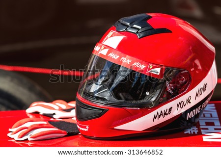 Ukraine, Kiev -  August 15, 2015: Red Ferrari helmet with gloves for riding on a racing car F1
