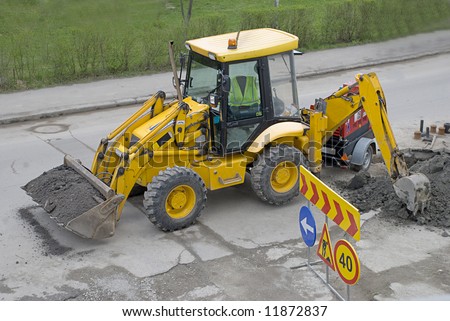 Yellow bulldozer with construction signs