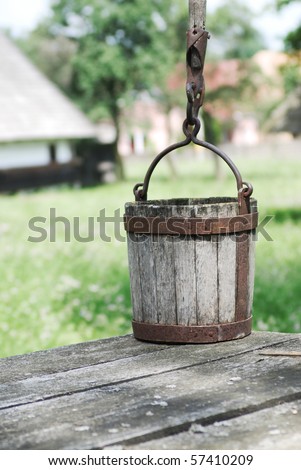 Old wooden water bucket, outside photograph with rural background
