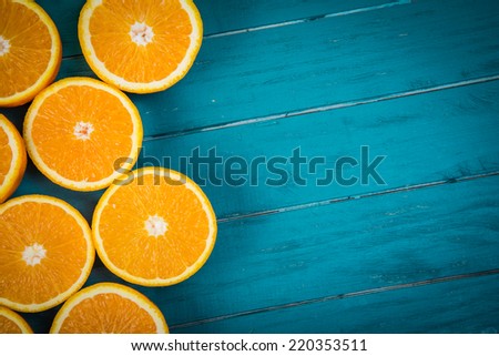 Fresh organic oranges halves  fruits on blue wooden background with copy space