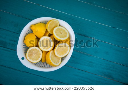 Market fresh organic lemons halves on wooden table background with copy space