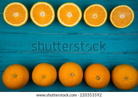 Fresh organic oranges fruits on blue wooden background with copy space