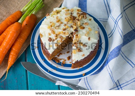 Carrot cake and cloth on table with fresh carrots