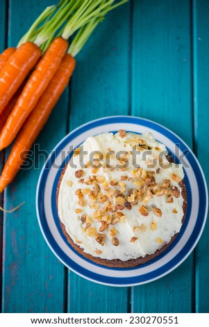 Traditional carrot cake and fresh carrots on table