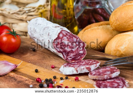 sliced salami and fork on board
