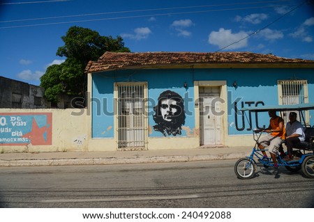 TRINIDAD, CUBA - DECEMBER 11, 2014: Cuban taxi bicycle ride on street of Trinidad,CUBA. Bicycle taxi can carry up to two people and its very popular with turist but also local people.