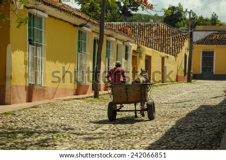 TRINIDAD, CUBA - MAY 26, 2013 Cuban local man drive horse carriage on street in UNESCO protected city of Trinidad, Cuba.