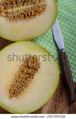 Melon fruit cut on rustic wooden board