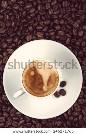overhead view on cup of espresso coffee  and roasted beans