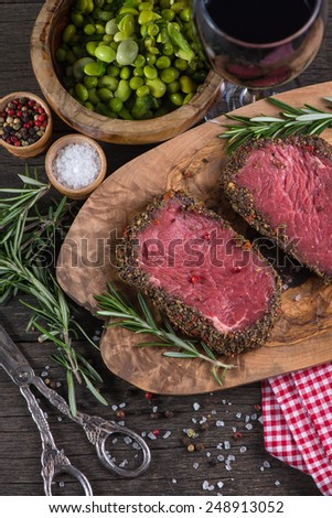Peppered beef steak with herbs in vintage kitchen