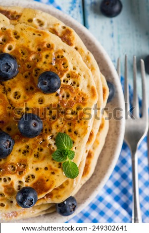 Homemade golden pancake with fresh berries and mint