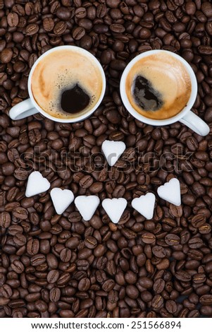 Funny smile face made of expresso coffee, sugar and roasted beans