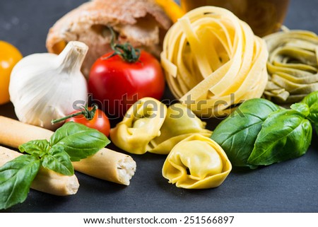 Selection of italian typical food on black background
