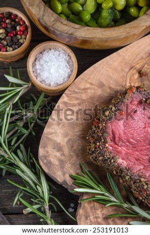 Peppered beef steak with herbs in vintage kitchen