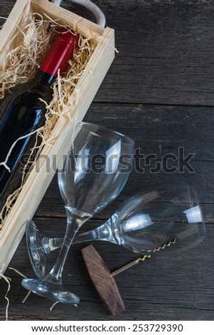 Vintage wooden wine case with bottle and glass on rustic background