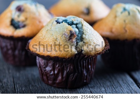 Blueberry muffins and fruit heart on wooden table