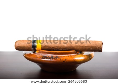 Cuban cigar isolated on wooden bar and white background