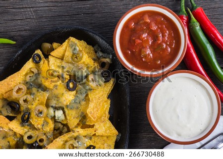 mexican hot street food nachos with salsa dip from above