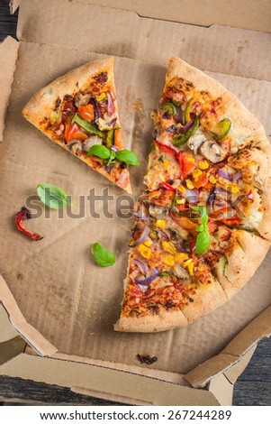 leftovers slices of homemade vegetarian pizza in box from above