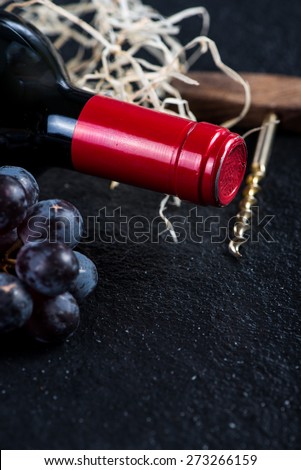 Red wine bottle with grapes and corkscrew,food border background