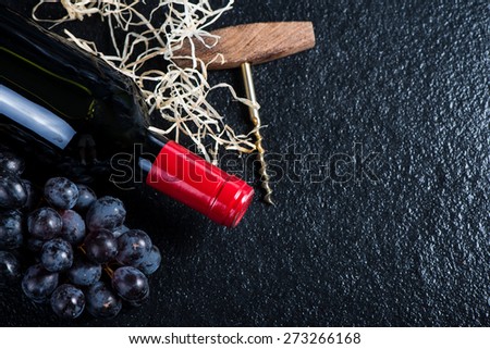 Red wine bottle with grapes and corkscrew,food border background