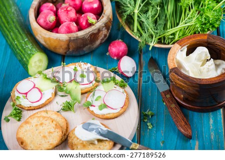 Healthy snacks,crackers with cottage cheese and fresh vegetables and herbs