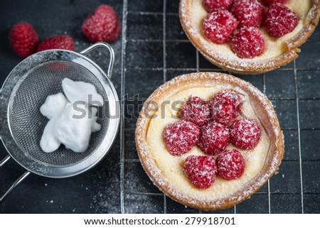 Traditional homemade fresh raspberry tart on cooling tray