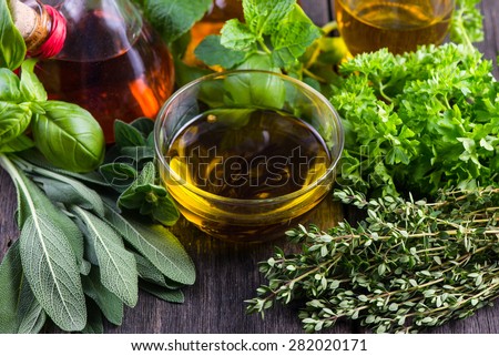 Fresh herbs from garden with olive oil, seasoning background