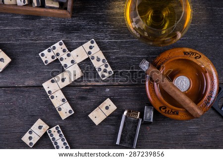 traditional cuban domino game, from above, with cigar and rum
