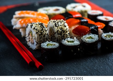 Sushi selection with chopsticks from above, food background