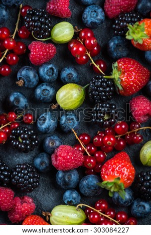 Mixed fresh ripe berries, food background from above