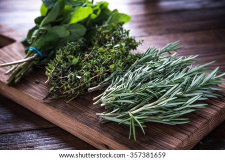 bunch of garden fresh herbs on wooden board from above