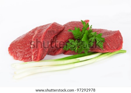 raw meat and vegetables on white