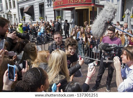 THE HAGUE, HOLLAND - MAY 3: Harry Styles of the boy band One Direction leaves Hotel des Indes among a crowd of teenage fans in The Hague, Holland on May 3, 2013