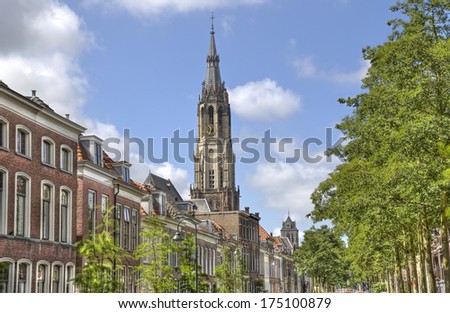 Church tower of Delft rises above the historical houses in Holland
