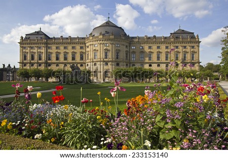 The Wurzburg Residence building and formal garden with flowers in Wurzburg, Germany