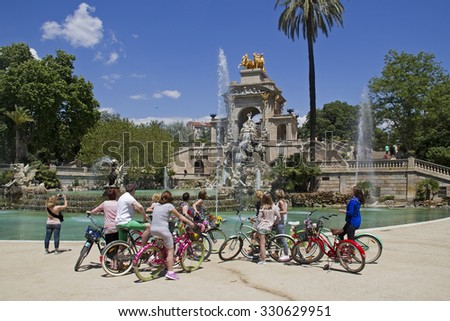 Barcelona, Spain - May 23, 2015: Tourist group on bicycles at the fountain in the Ciutadella Park in Barcelona, Spain on May 23, 2015.